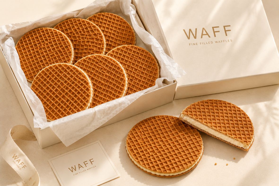 An open WAFF gift box of waffles with ribbon and card
